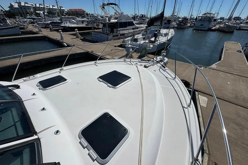 Lone Star Yacht Photos Pics 2005 Tiara Yachts 3200 Open docked at a marina, showcasing its sleek deck design.