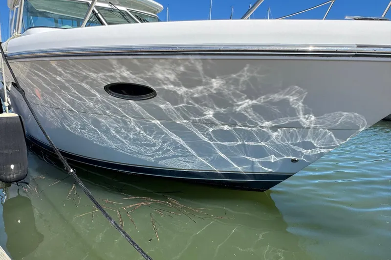 Lone Star Yacht Photos Pics 2005 Tiara Yachts 3200 Open reflecting water patterns on hull in marina.