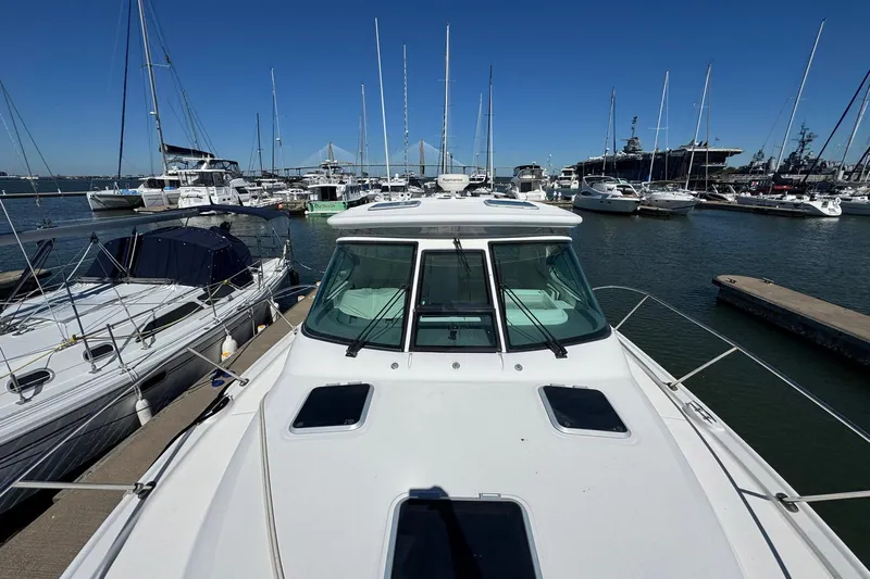 Lone Star Yacht Photos Pics 2005 Tiara Yachts 3200 Open docked in a marina with other boats.