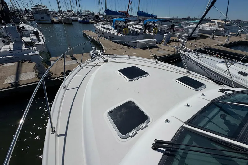 Lone Star Yacht Photos Pics 2005 Tiara Yachts 3200 Open docked at marina, surrounded by sailboats.