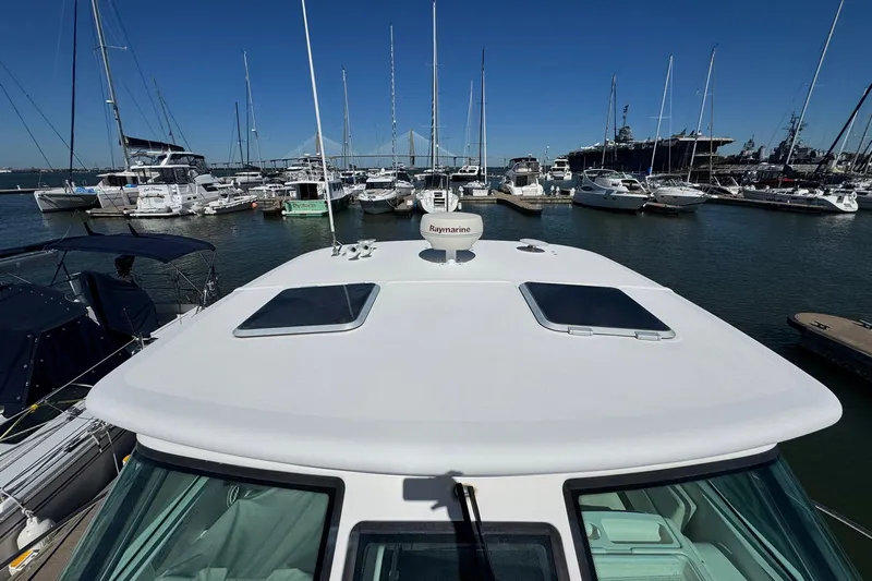 Lone Star Yacht Photos Pics 2005 Tiara Yachts 3200 Open docked in a marina with other boats.