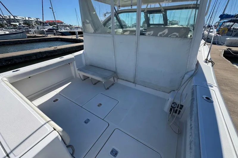 Lone Star Yacht Photos Pics 2005 Tiara Yachts 3200 Open boat interior, docked at marina, spacious deck area.