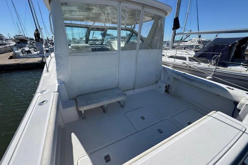 Lone Star Yacht Photos Pics 2005 Tiara Yachts 3200 Open boat docked, featuring spacious deck and seating area.