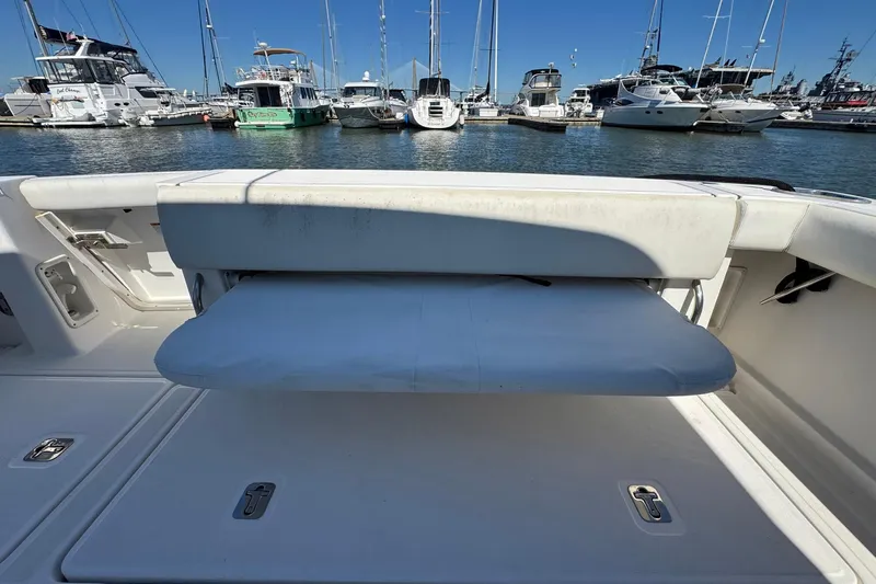 Lone Star Yacht Photos Pics 2005 Tiara Yachts 3200 Open boat with foldable seating, docked in a marina.