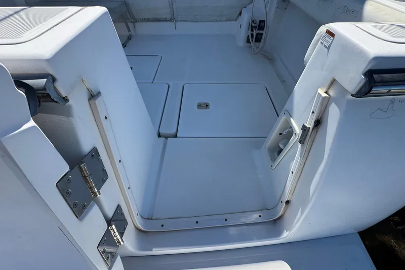 Lone Star Yacht Photos Pics 2005 Tiara Yachts 3200 Open boat interior with white seating and storage compartments.