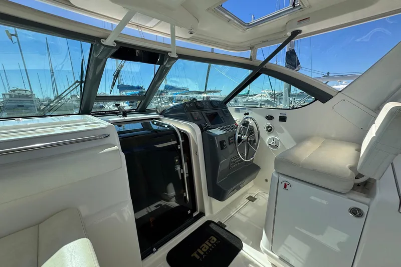 Lone Star Yacht Photos Pics 2005 Tiara Yachts 3200 Open cockpit with steering wheel and navigation controls.