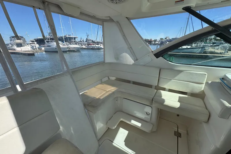 Lone Star Yacht Photos Pics Interior of 2005 Tiara Yachts 3200 Open, featuring white seating and marina view.