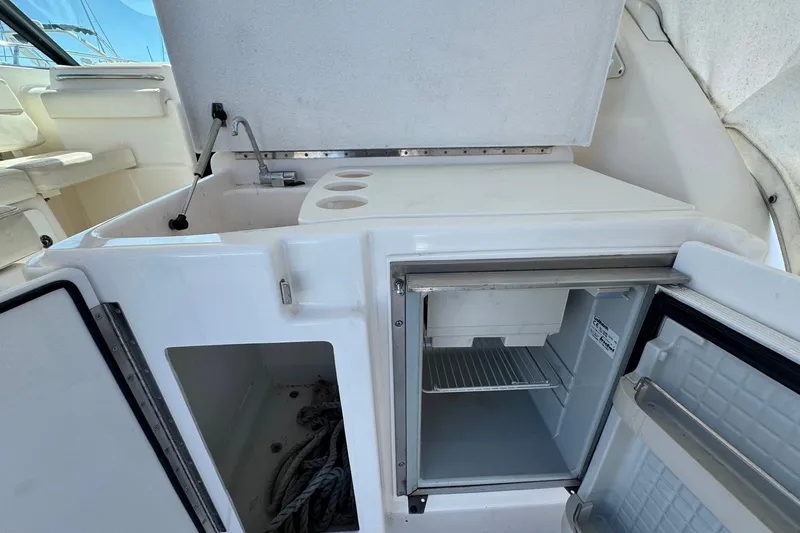 Lone Star Yacht Photos Pics 2005 Tiara Yachts 3200 Open interior with open fridge and storage compartments.