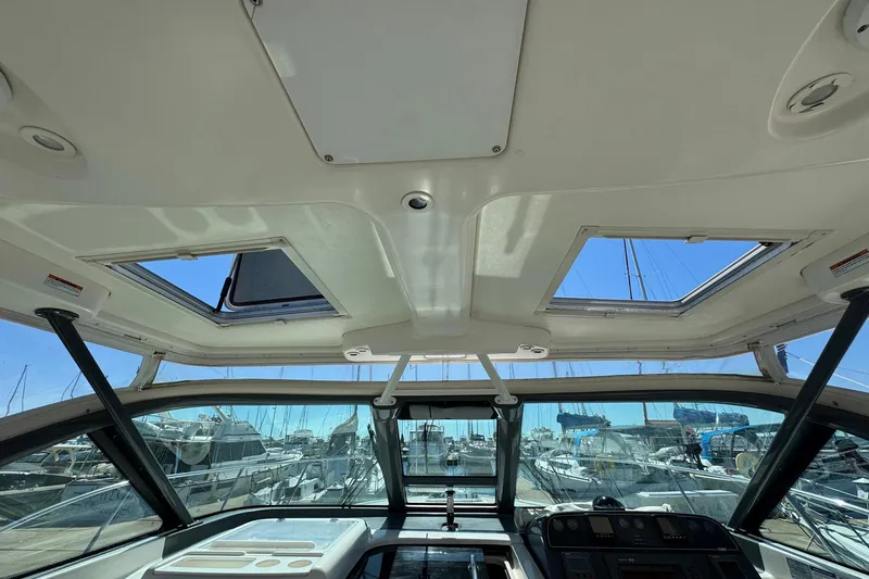Lone Star Yacht Photos Pics Interior view of 2005 Tiara Yachts 3200 Open, showcasing helm and overhead windows.