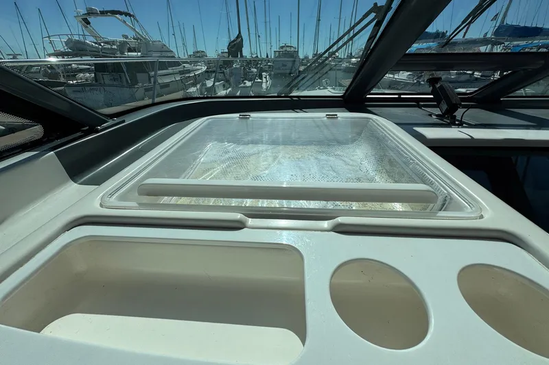 Lone Star Yacht Photos Pics 2005 Tiara Yachts 3200 Open cockpit with marina view, showcasing sleek design and functionality.