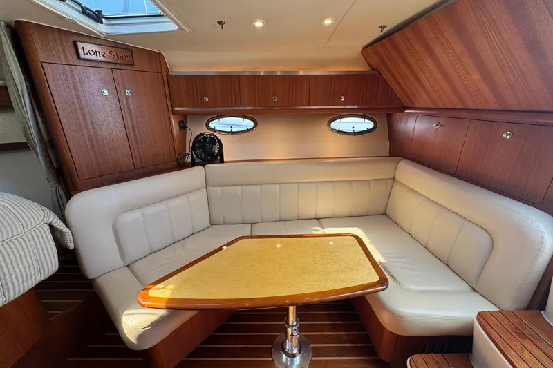 Lone Star Yacht Photos Pics Luxurious 2005 Tiara Yachts 3200 Open interior with elegant wood and leather seating.