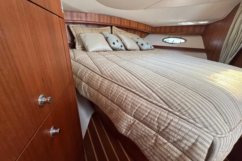 Lone Star Yacht Photos Pics Luxurious cabin interior of 2005 Tiara Yachts 3200 Open with cozy bedding.
