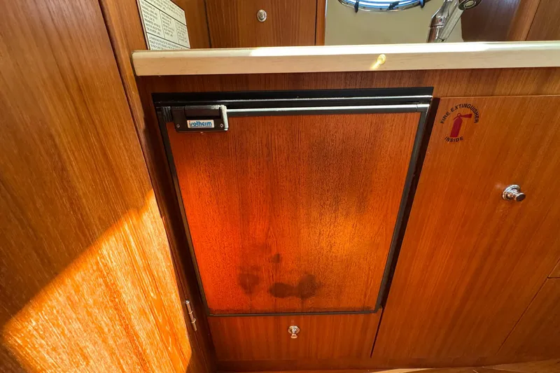 Lone Star Yacht Photos Pics 2005 Tiara Yachts 3200 Open interior with wooden cabinetry and built-in fridge.