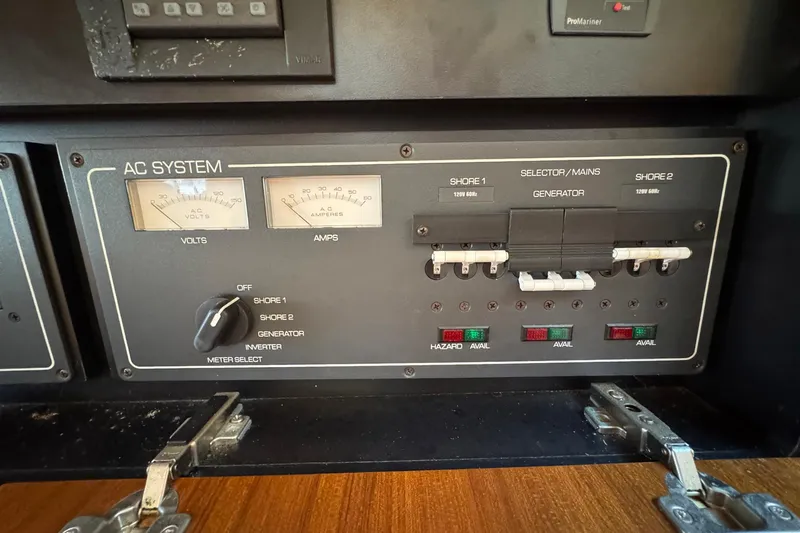 Lone Star Yacht Photos Pics AC system panel on a 2005 Tiara Yachts 3200 Open, showing voltage and amperage meters.