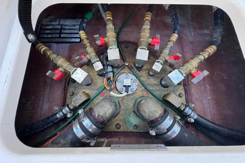 Lone Star Yacht Photos Pics Engine compartment of a 2005 Tiara Yachts 3200 Open, showing valves and hoses.