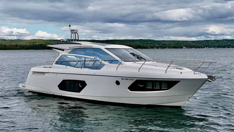 Yes Dear! Yacht Photos Pics 2016 Absolute Sport Yacht cruising on a scenic lake under cloudy skies.