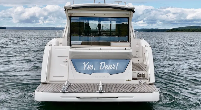 Yes Dear! Yacht Photos Pics 2016 Absolute Sport Yacht on water, rear view with "Yes, Dear!" sign.