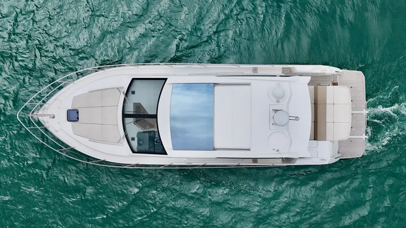 Yes Dear! Yacht Photos Pics Overhead view of a 2016 Absolute Sport Yacht cruising on turquoise water.