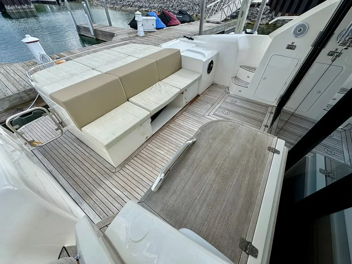 Yes Dear! Yacht Photos Pics 2016 Absolute Sport Yacht interior with beige seating and wooden deck at a marina.