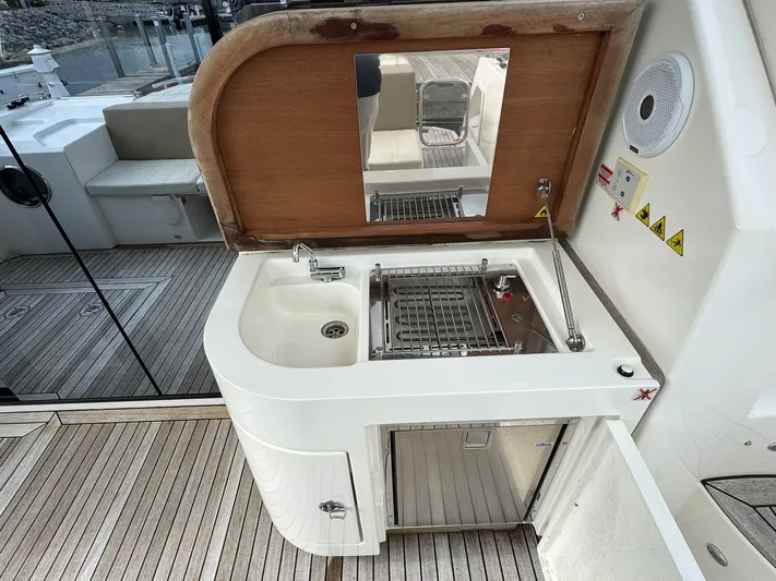 Yes Dear! Yacht Photos Pics Outdoor kitchenette on 2016 Absolute Sport Yacht with sink, grill, and storage.