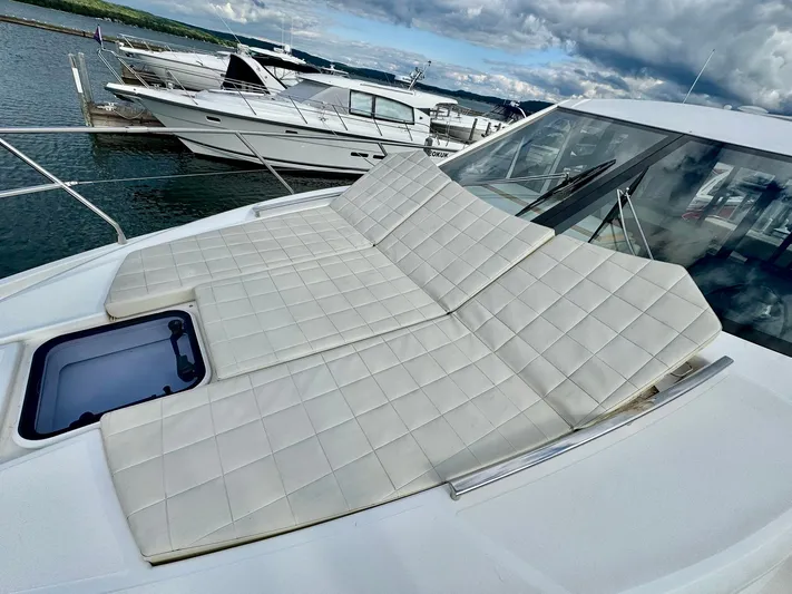 Yes Dear! Yacht Photos Pics 2016 Absolute Sport Yacht with cushioned sunbathing area, docked at marina.
