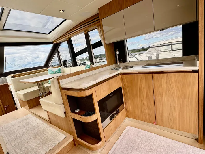 Yes Dear! Yacht Photos Pics Luxurious interior of a 2016 Absolute Sport Yacht with modern kitchen and seating area.