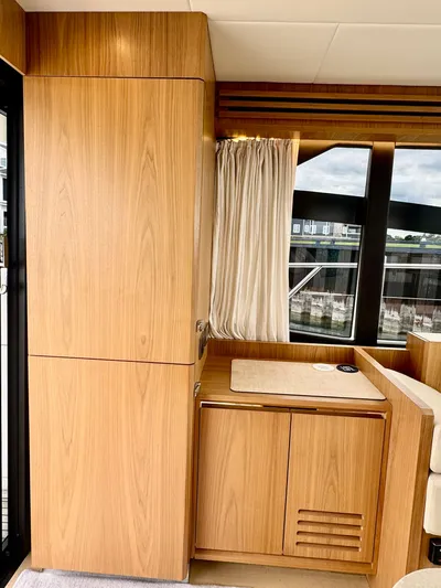 Yes Dear! Yacht Photos Pics Interior of 2016 Absolute Sport Yacht with wooden cabinetry and large windows.