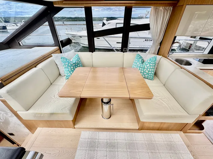 Yes Dear! Yacht Photos Pics Luxurious 2016 Absolute Sport Yacht interior with elegant seating and wooden table.