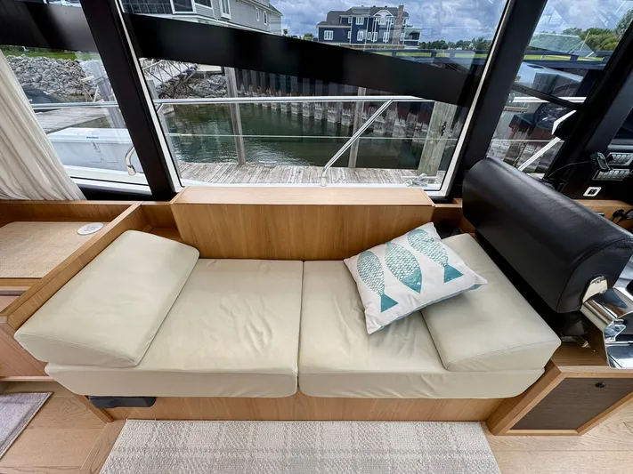 Yes Dear! Yacht Photos Pics Interior of 2016 Absolute Sport Yacht with beige seating and decorative fish pillow.