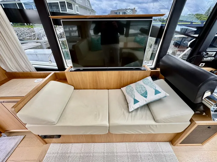 Yes Dear! Yacht Photos Pics Luxurious interior of a 2016 Absolute Sport Yacht with a cozy seating area and TV.