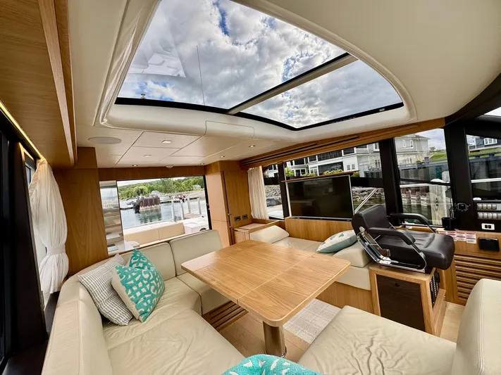 Yes Dear! Yacht Photos Pics Luxurious interior of a 2016 Absolute Sport Yacht with skylight and modern furnishings.
