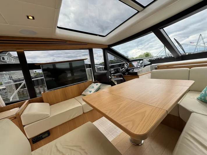 Yes Dear! Yacht Photos Pics Luxurious interior of a 2016 Absolute Sport Yacht with modern seating and panoramic windows.