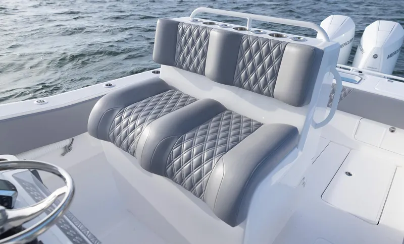  Yacht Photos Pics 2025 Invincible 33 Open Fisherman boat with luxurious quilted seating on open water.
