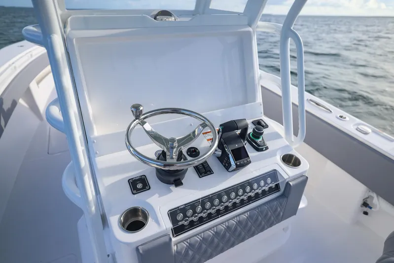  Yacht Photos Pics 2025 Invincible 33 Open Fisherman boat console with steering wheel and controls.