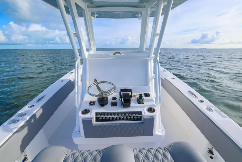  Yacht Photos Pics 2025 Invincible 33 Open Fisherman boat on open water, featuring modern helm controls.