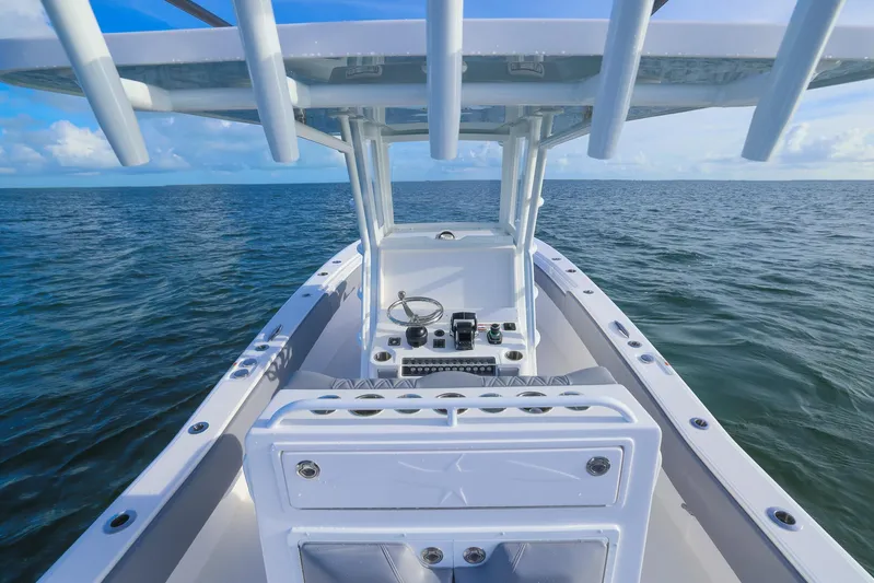  Yacht Photos Pics 2025 Invincible 33 Open Fisherman boat on open sea, clear sky.