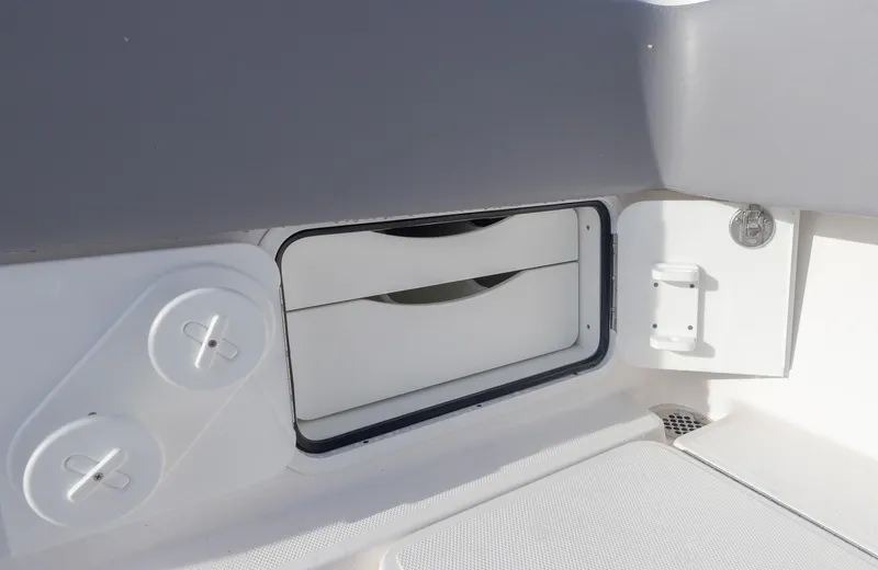  Yacht Photos Pics 2025 Invincible 33 Open Fisherman storage compartment with white interior.