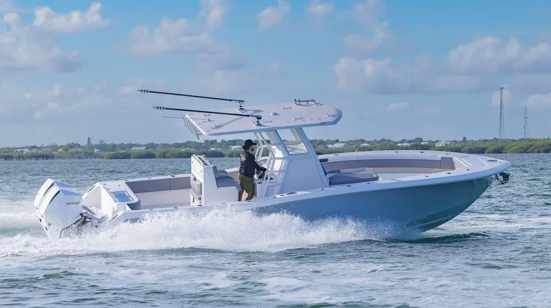  Yacht Photos Pics 2025 Invincible 33 Open Fisherman boat cruising on open water.