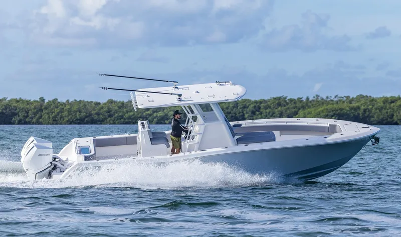  Yacht Photos Pics 2025 Invincible 33 Open Fisherman boat cruising on water.