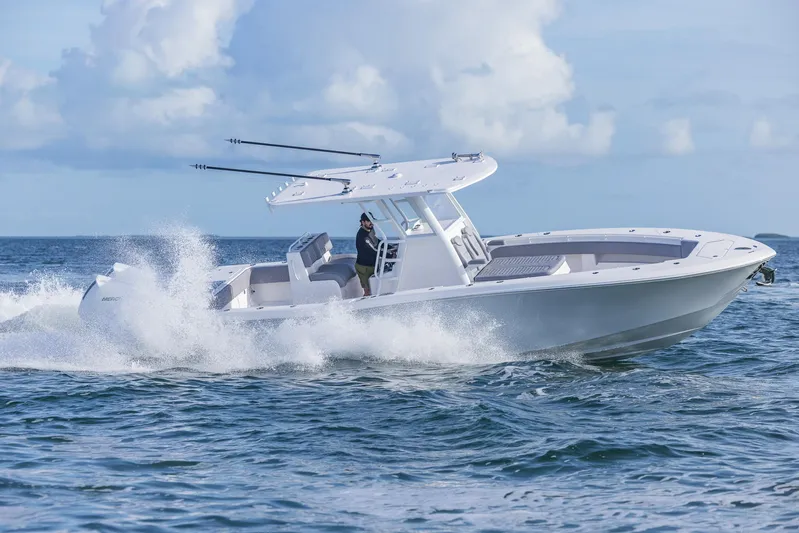  Yacht Photos Pics 2025 Invincible 33 Open Fisherman boat cruising on ocean waves.