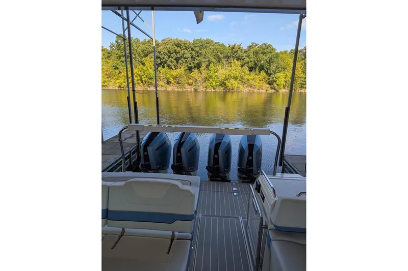  Yacht Photos Pics 2024 Formula 430 Super Sport Crossover boat with multiple outboard engines on a serene lake.