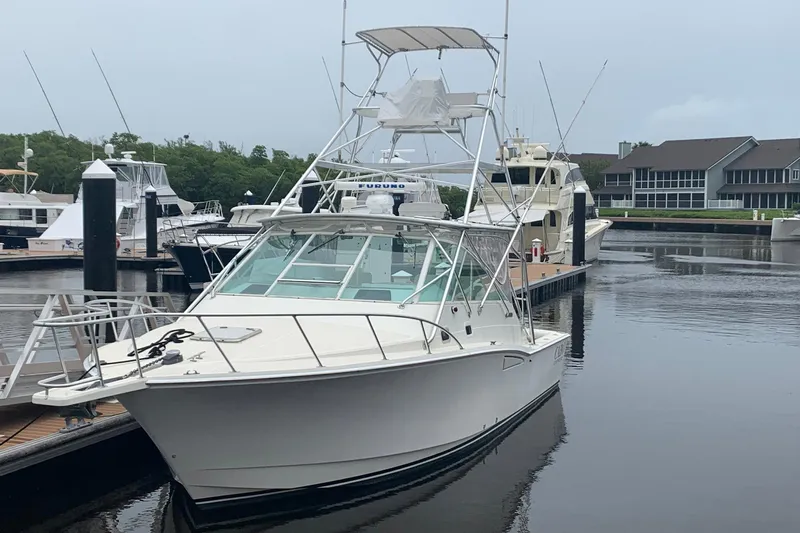 Dream Weaver Yacht Photos Pics 2002 Cabo 35 Express boat docked in a marina, surrounded by other vessels.