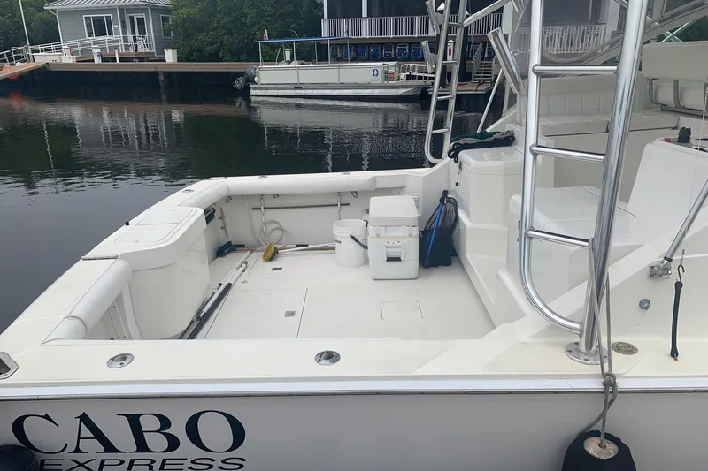Dream Weaver Yacht Photos Pics 2002 Cabo 35 Express boat docked, featuring spacious deck and fishing equipment.
