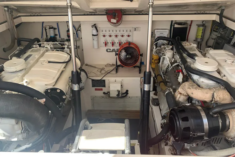 Dream Weaver Yacht Photos Pics Engine room of a 2002 Cabo 35 Express boat, featuring dual engines and control panel.