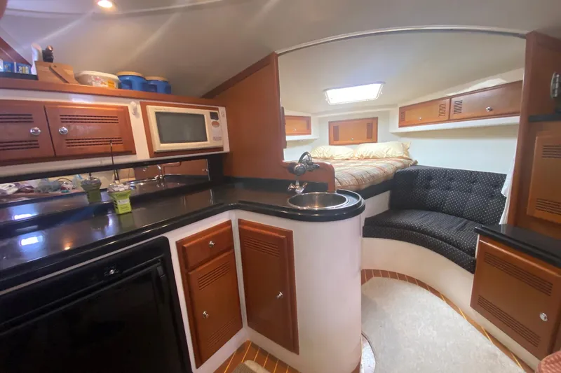 Dream Weaver Yacht Photos Pics 2002 Cabo 35 Express interior with kitchen, bed, and seating area.
