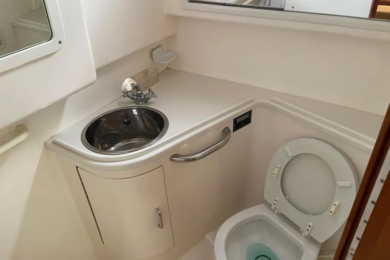 Dream Weaver Yacht Photos Pics Compact bathroom in 2002 Cabo 35 Express boat with sink and toilet.