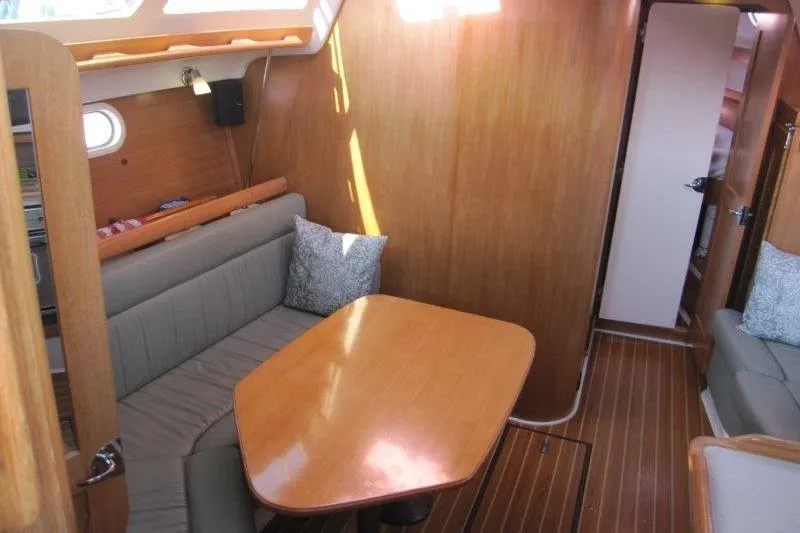 Sassy Cat Yacht Photos Pics Interior of 2004 Catalina 350 MkII sailboat with wooden dining area and seating.