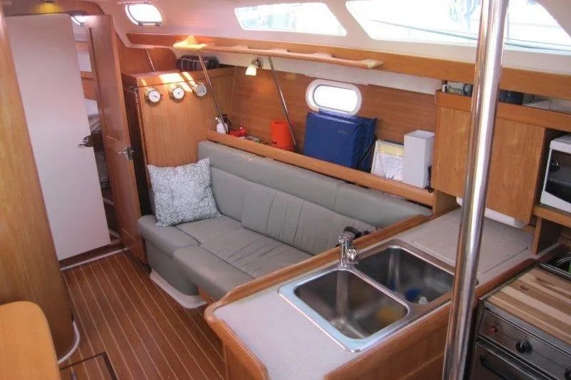 Sassy Cat Yacht Photos Pics Interior of 2004 Catalina 350 MkII sailboat with cozy seating and kitchen area.