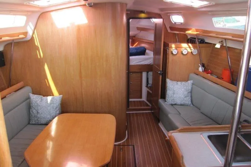 Sassy Cat Yacht Photos Pics Interior of a 2004 Catalina 350 MkII sailboat with wood finish and cozy seating area.