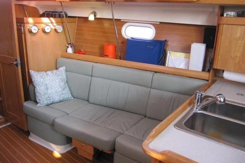 Sassy Cat Yacht Photos Pics Interior of 2004 Catalina 350 MkII sailboat with cozy seating and kitchenette.